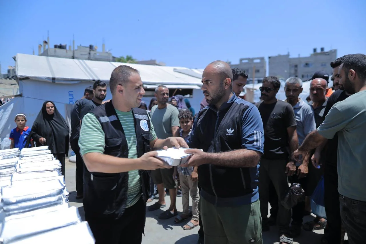 Aid workers coordinating a community distribution outdoors