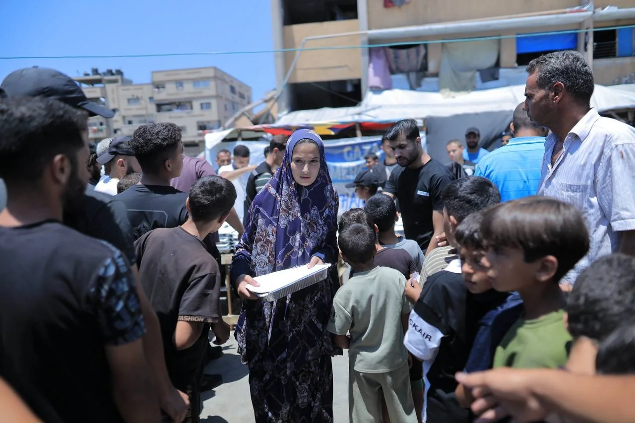 Community members gathered around an aid distribution
