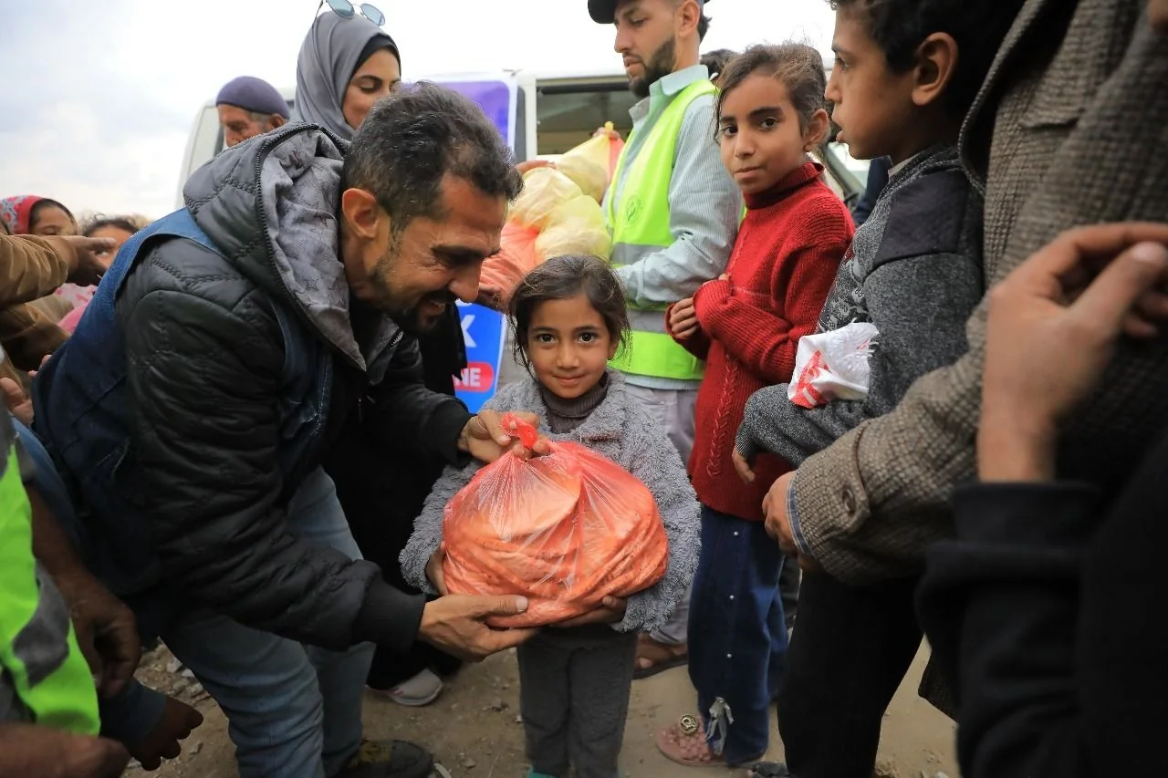 A child receiving a food parcel during a relief distribution