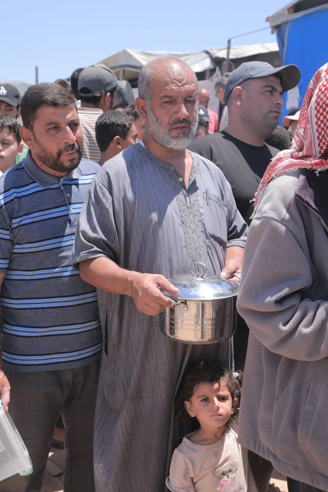 People receiving prepared meals during an aid distribution